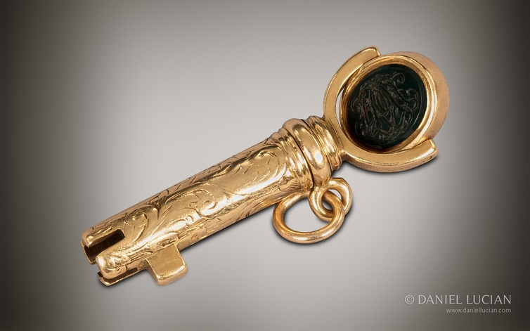 Bramah master key in 15k gold with revolving monogramed intaglio.