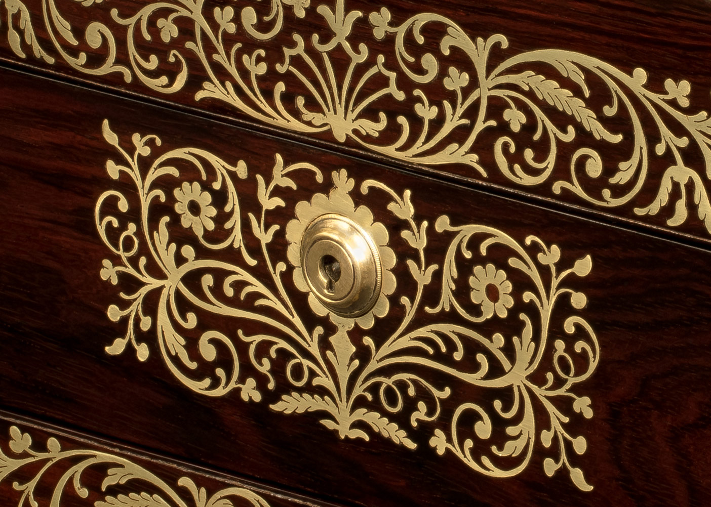 Inlaid foliate brass designs on an antique jewellery box in rosewood, by Charles Essex.