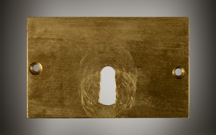 Concealing front plate from an antique George Davis Patent lock.