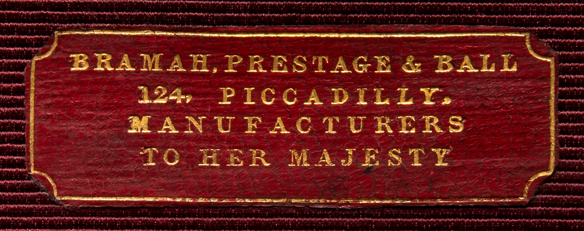 A leather label on the interior of the lid bears the gold tooled manufacturer’s and retailer’s mark of, ‘Bramah, Prestage & Ball – 124, Piccadilly. Manufacturers to Her Majesty’.