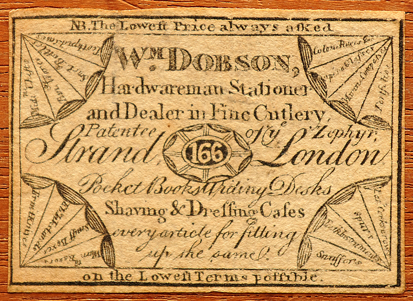 Opening the lower drawer reveals the manufacturer’s label adhered to the interior lid section. This paper label bears the mark of the manufacturer, William Dobson of 166 Strand, London.