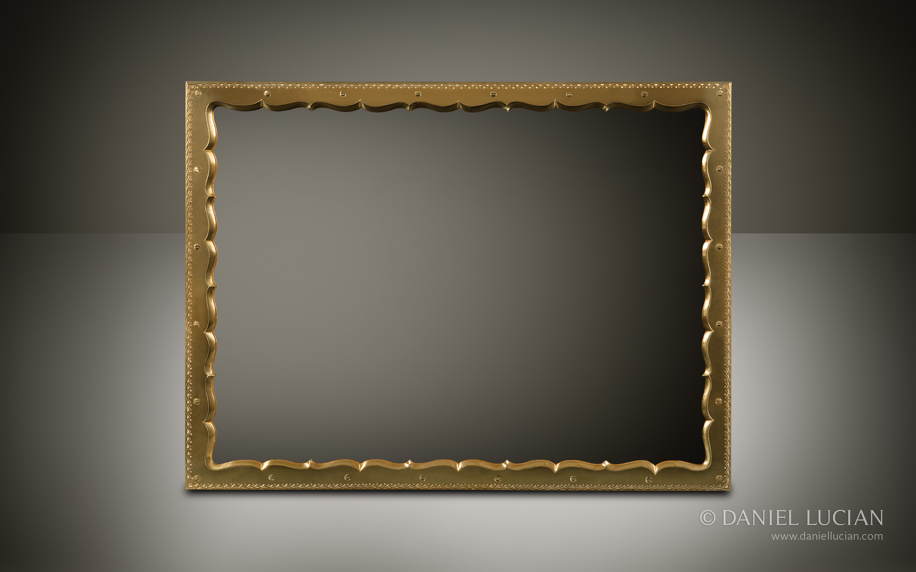 An ornately shaped and engraved brass framed mirror from an antique jewellery box with Betjemann Patent ‘Automatic’ mechanism by Howell, James & Co.