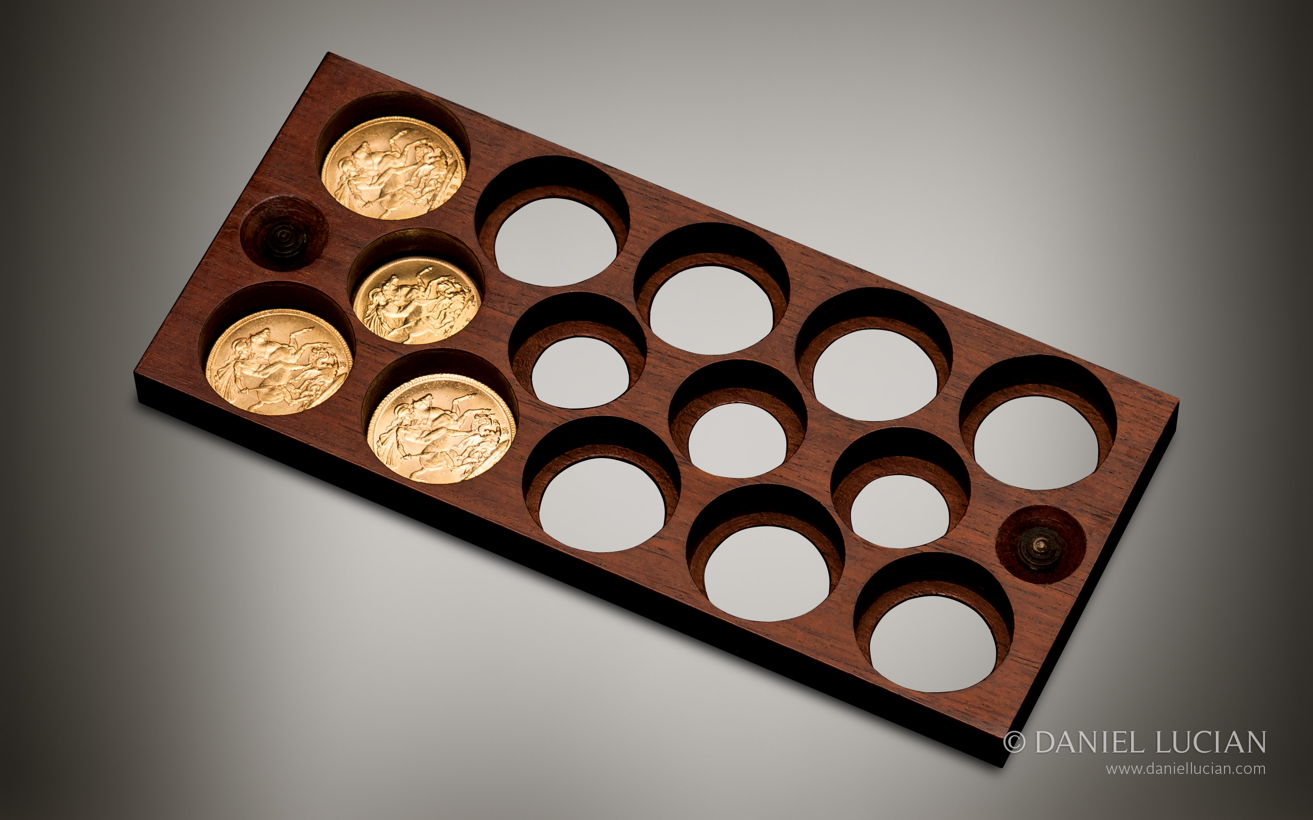 Gold sovereign holder from an antique jewellery box in coromandel with brass inlay and secret compartments, by Asprey.